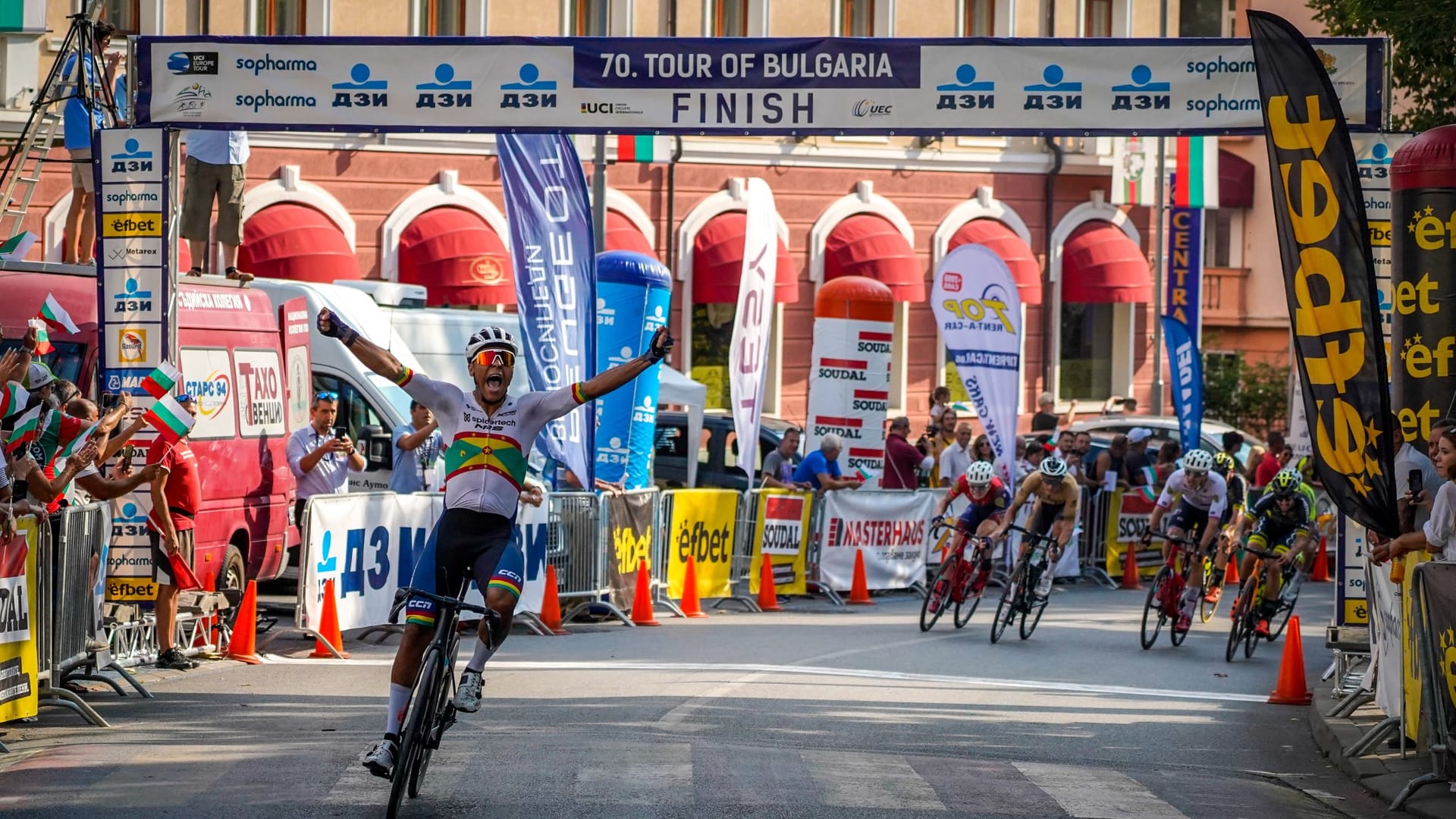 Red Walters crossing the finish line with arms raised at the Tour of Bulgaria